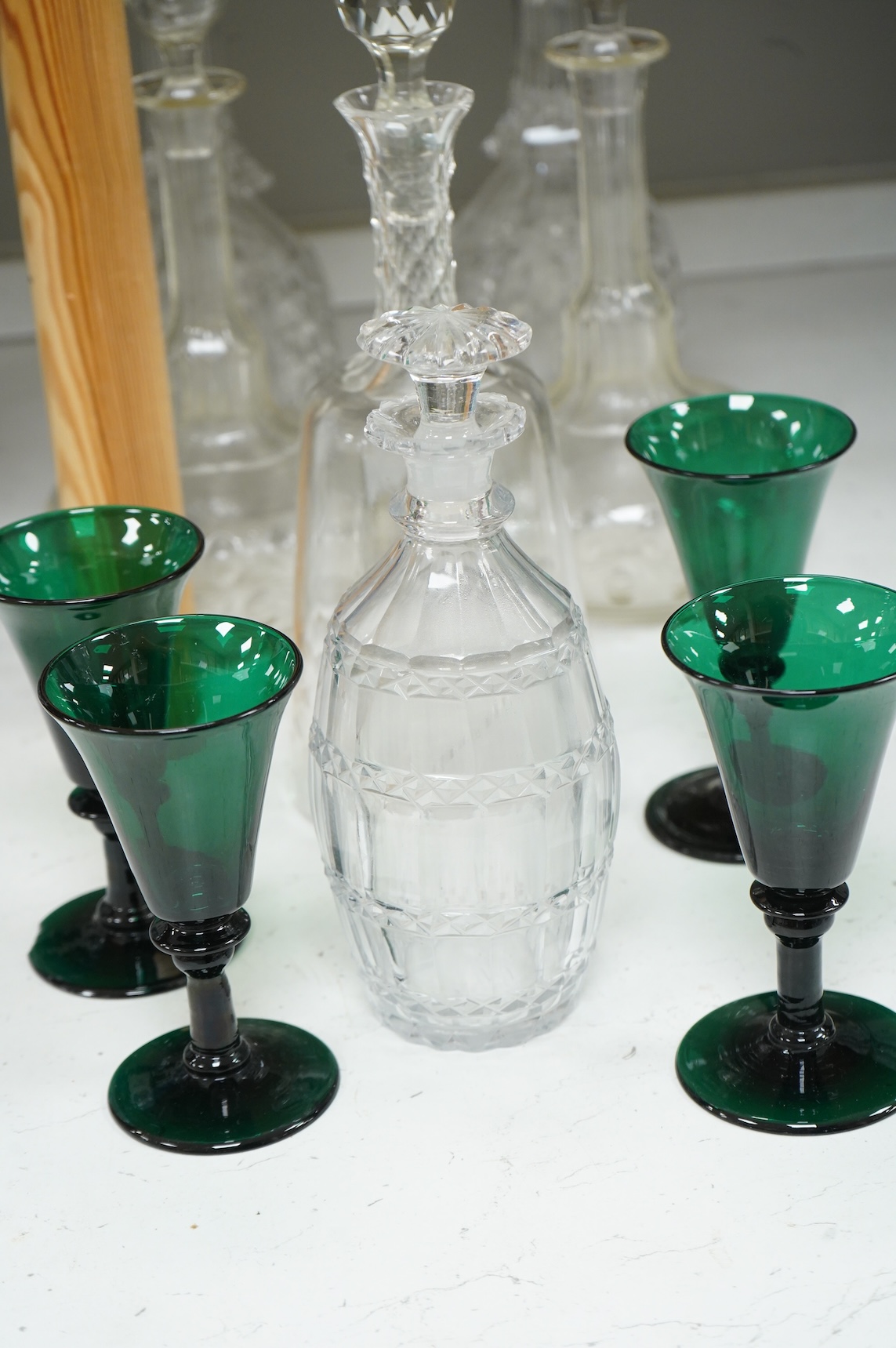 A set of four 19th century Bristol green glasses, an early 19th century spirit decanter and other Victorian decanters